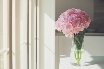 Beautiful pink hydrangea in the vase. Lifestyle cosy shot.