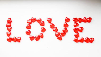The word LOVE is made of little red hearts on a white background. The concept of holidays and Valentine's Day