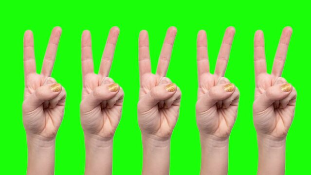 Multiple female hands making peace sign