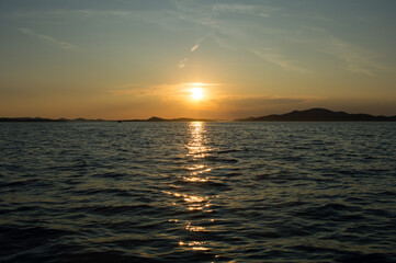 Stunning sunset over the Adriatic sea, near Zadar and Kornati islands. Sunlight reflecting on the water surface