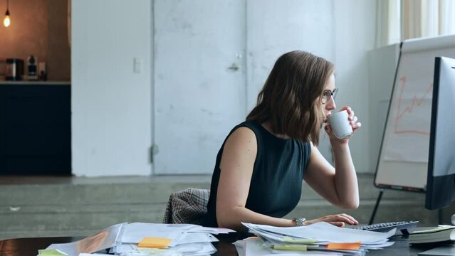 Chest shot video of beautiful but busy business woman at office having too much work, forgetting time and running late. Concept: too late for it and leaves in a hurry. 