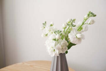 Beautiful flowers in gray vase on neutral background. Mother's day, Father's day flower gift image background.