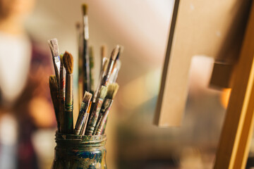 Close up of jar full of paintbrushes 