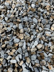 large vertical photo. gray wet rubble top view closeup. construction material. off-road.