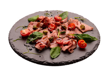 sliced roast beef on slate board, isolated on white