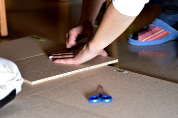 A woman doing DIY at home.  Unrecognizable person. Photography with copy space. Selective focus