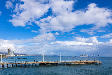 Obraz premium Blue sky with gray clouds above sea piers, Limassol, Cyprus 