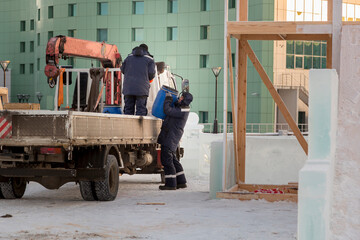 A worker unloads a barrel from a car body