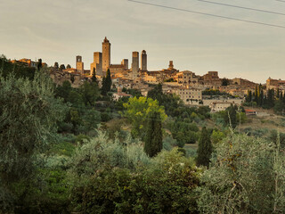 Fototapeta na wymiar Typical Tuscany old city with beautiful stone towers in golden hour sunlight, Italy