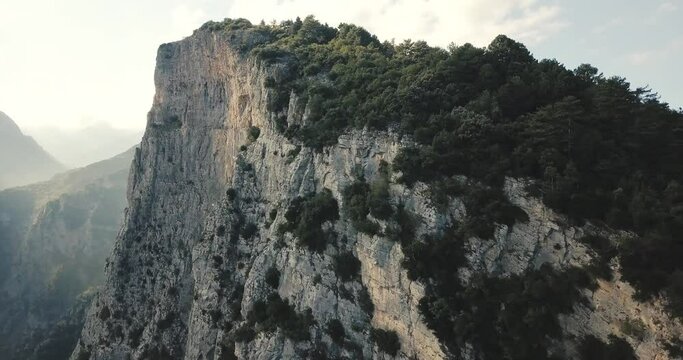 Aerial drone flight into deep gorge and rocky ridge leading to legendary Mountain Olympus - the pantheon of all Greek gods and Great Zeus. Natural and National Parks in Greece