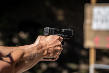 shooting from a pistol at a target on a shooting range