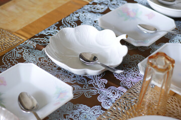 cutlery and empty plate on wooden background top down