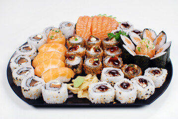 Japanese food combo of sushis and sahimis in white background
