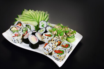 Japanese food combo of sushis and sahimis in black background