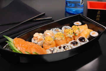 Japanese food combo of sushis and sahimis in white background