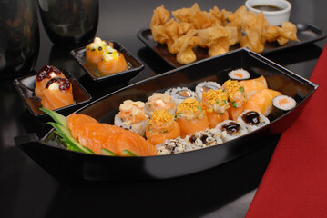 Japanese food combo of sushis and sahimis in white background