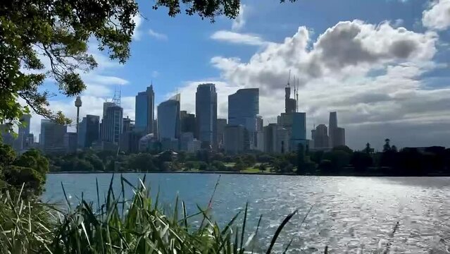Timelapse of Sydney Harbour with view of Sydney CBD skyline under blue sky and white clouds