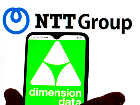 In this photo illustration, the Dimension Data logo is displayed on a smartphone screen with the Nippon Telegraph and Telephone Corporation logo in the background.