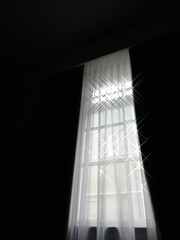 semi-abstract picture of long tall window with sunlight streaming in