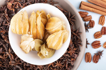 Star anise seasoning in a plate on a light tablecloth