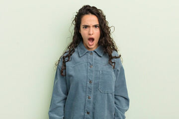 hispanic pretty woman looking shocked, angry, annoyed or disappointed, open mouthed and furious
