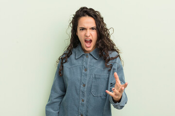 hispanic pretty woman looking angry, annoyed and frustrated screaming wtf or what’s wrong with you