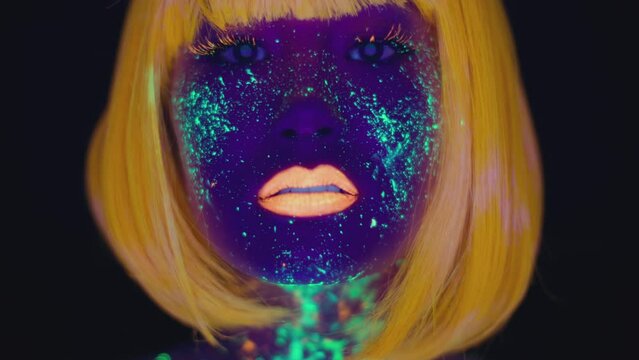 Privacy concept. Young mysterious lady with neon makeup and orange wig showing shh gesture, putting finger on lips