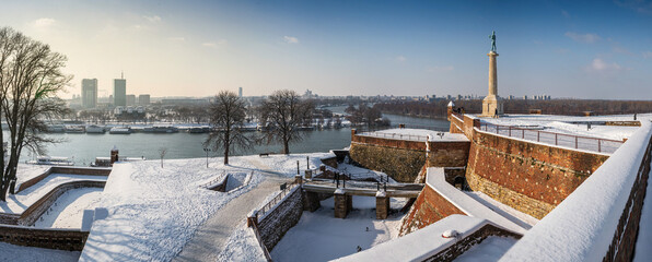 Winter panorama of Belgrade Kalemegdan fortress, Victor Monument, Sava river and New Belgrade by sunny day with snow