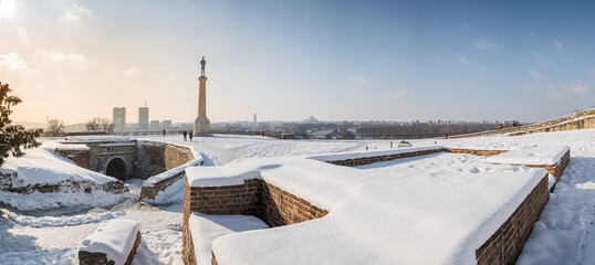 Winter panorama of Belgrade Kalemegdan fortress, Victor Monument, Sava river and New Belgrade by day with snow