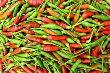 Fresh green and red chili peppers photo background top view 