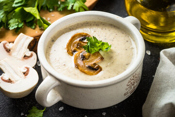 Mushroom Soup on dark stone table. Healthy vegan dish. Autumn soup.