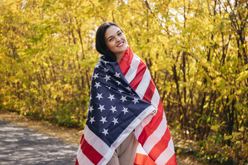 Happy smiling young woman with american flag