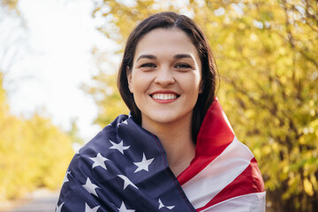 Happy smiling young woman with american flag