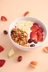 bowl of granola cereal with yogurt and berries isolated on eggnog color background