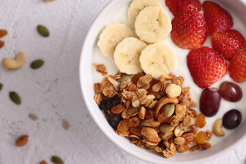 bowl of granola cereal with yogurt and berries isolated on white background