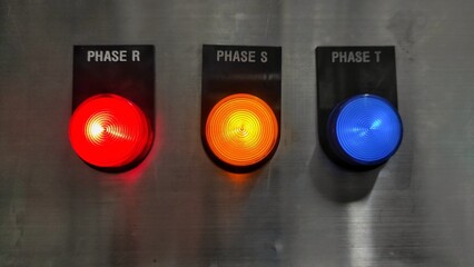 Red, yellow and blue colours of indicator light machine in the factory