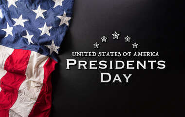Fototapeta na wymiar Happy presidents day concept with flag of the United States and the text on dark background.