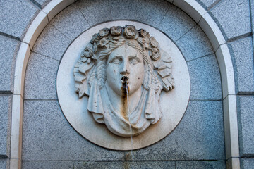 neoclassical stone face on a fountain