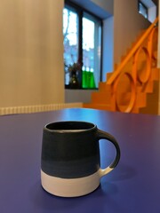 cup of coffee on blue table