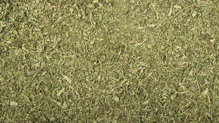 texture of green dried cannabis leaves, marijuana background..