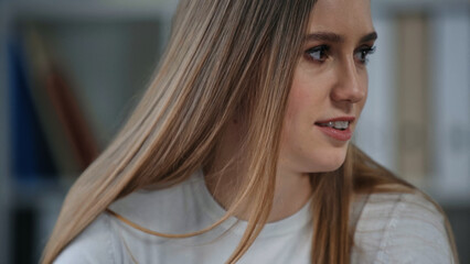 young woman smiling while looking away in office