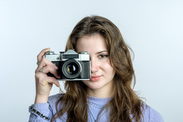 Portrait of a photographer girl. Beginner photographer. Old film camera.