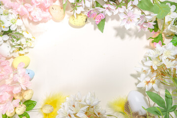 Naklejka na ściany i meble Easter holiday top view flat lay frame background with easter colorful eggs, and spring flowers. Spring holiday greeting card background, copy space