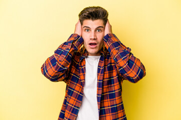 Young caucasian man isolated on yellow background being shocked, she has remembered important...
