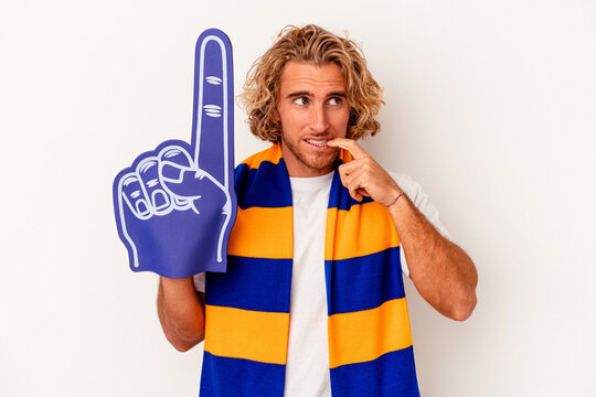 Young Sports Caucasian Fan Man Isolated On White Background Biting Fingernails, Nervous And Very Anxious.