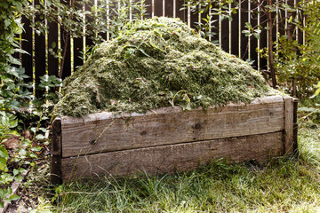 Conpost pile with Organic Waste, mown grass cutting, Composter of bio waste, Composting concept, bin