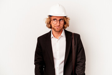 Young architect caucasian man with helmet isolated on white background confused, feels doubtful and unsure.