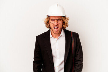 Young architect caucasian man with helmet isolated on white background screaming very angry and aggressive.