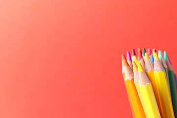 Colored pencils on red background