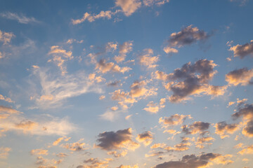 Beautiful cumulus clouds in the blue sky at sunset. To replace the sky in photos and illustrations.